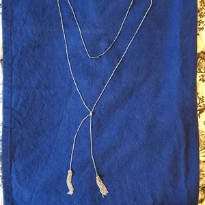 Super long knotted and tasseled silver station necklace